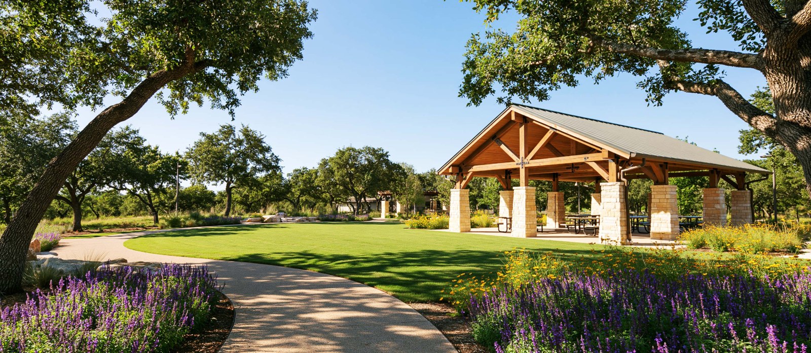 Illustrative community green with a limestone and timber picnic pavilion and flowering beds.